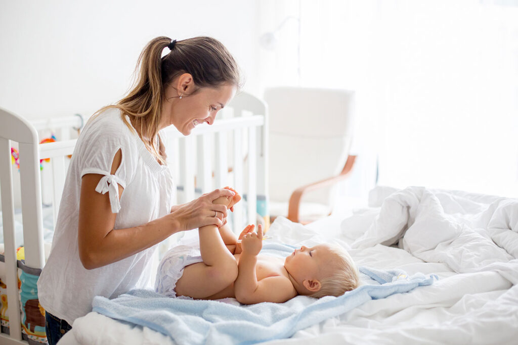 A mom is playing with her baby