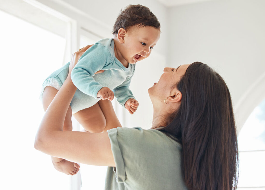 a mom holding baby up