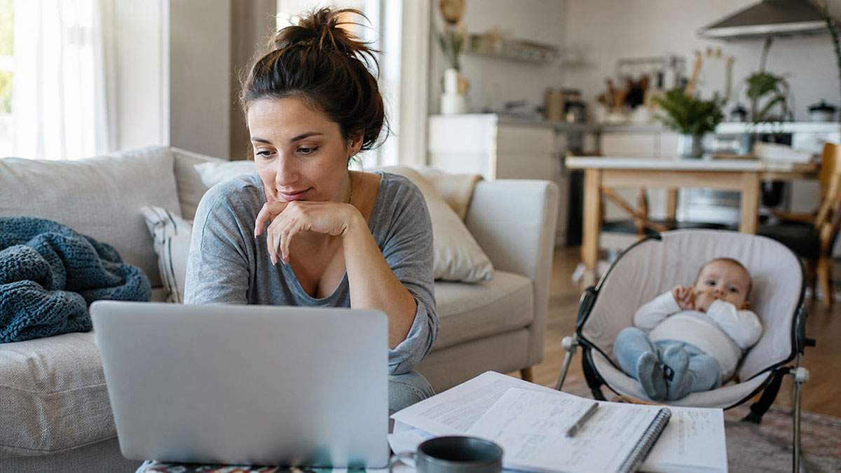 A mother reviewing maternity benefits and reimbursement documents for postpartum care on a laptop